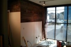 Wall clad in reclaimed lumber 1